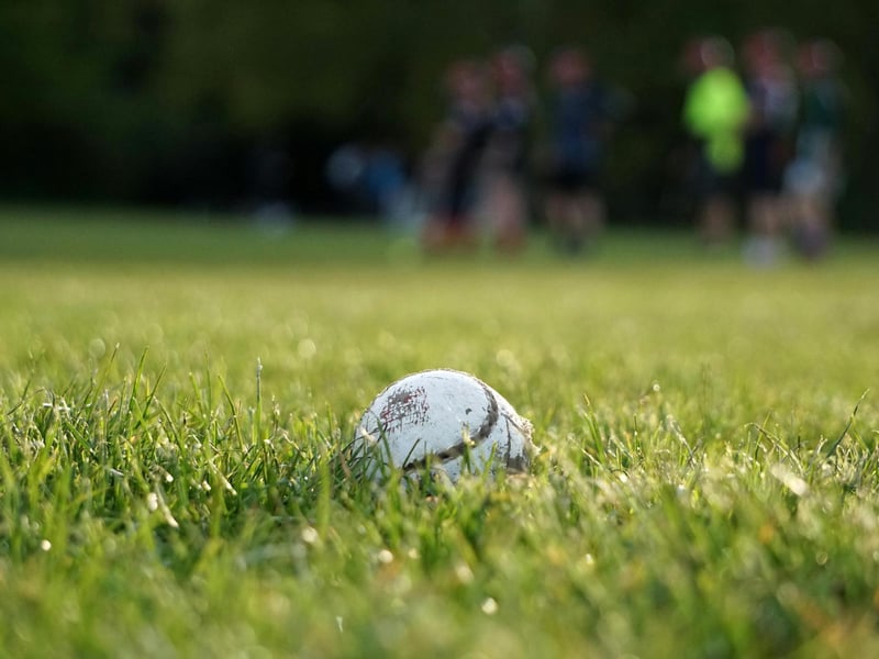 Shinty, a stick-and-ball game very similar to Camán and modern-day hurling, was once played in Northern Ireland.  Although they sound the same in theory, the difference between Shinty and Camán were different in play. Whereas Shinty is played with two teams on a larger field, and players can hit the ball both on the ground and in the air, Camán was more informal, with fewer standardised rules, and eventually evolved into modern hurling under the GAA. Brought over by Scottish immigrants, blending Irish and Scottish sporting traditions, it was played outdoors and consisted of two opposing teams attempting to hit a small ball through their opponents’ goal using sticks.  The game was part of community life in Northern Ireland and was often played during seasonal gatherings, bringing villages together for spirited competitions and entertainment. Over time this sport has eventually lost prominence as modern Gaelic games have become dominant throughout the country. Despite its decline in Ireland, the shared heritage of Shinty and Camán is celebrated through occasional shinty-hurling matches, where teams compete in a hybrid version of the two sports.
