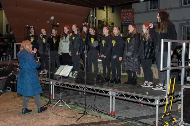 Raise the Roof choir performing on stage in Ballymena.