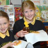 Louise and Chloe ready to tuck into their pancakes at Larne and Inver Primary School in 2011. Photo: Peter Rippon