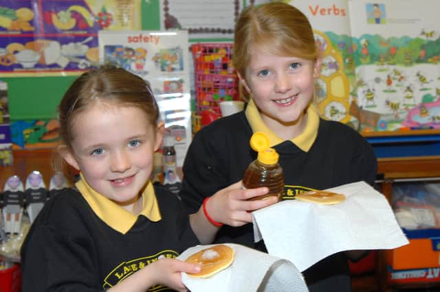 Louise and Chloe ready to tuck into their pancakes at Larne and Inver Primary School in 2011. Photo: Peter Rippon