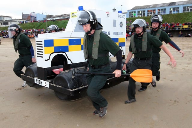 On the run are members of Maydown PSNI Rubies TSG raft team as they make their way to the beach at Portrush Raft Race in 2010
