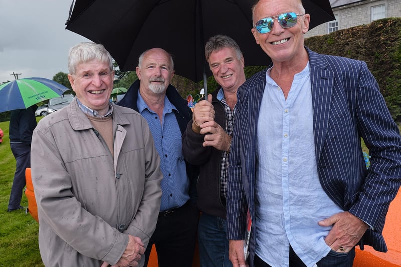 Andy Sinclair, Frank Bigmore, William Ferguson and Sean Henry shelter from a shower during the Desertmartin Parish Church Garden Fete and Vintage Rally.