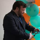 Oscar winning actor James Martin cuts the ribbon to mark the official opening of Fairhill Court in Maghera. Credit: NHSCT