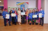 Richard Pengelly, EA chief executive and Martina Coogan, from the EA Addressing Bullying in Schools Implementation Team, holding the informational leaflets, with Noella Murray, principal of St John the Baptist College, Portadown, and pupils. Photo: LiamMcArdle.com
