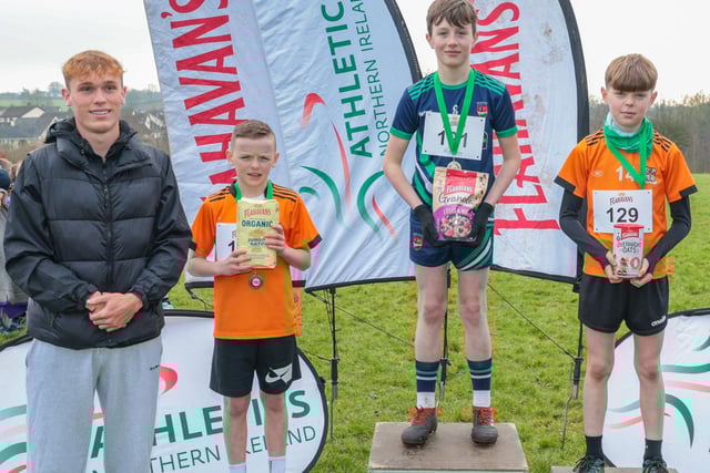 (L-R): Callum Baird, Athletics NI and Flahavan’s League Ambassador, Dermot Doran from Ballymacrickett Primary School (2nd), Charlie McCann from Moneynick Primary School (1st), and Kye Connere from Ballymacrickett Primary School (3rd) at the third round of the 2024-2025 Flahavan’s Athletics NI Primary School Cross Country League at Sixmile Water Park.