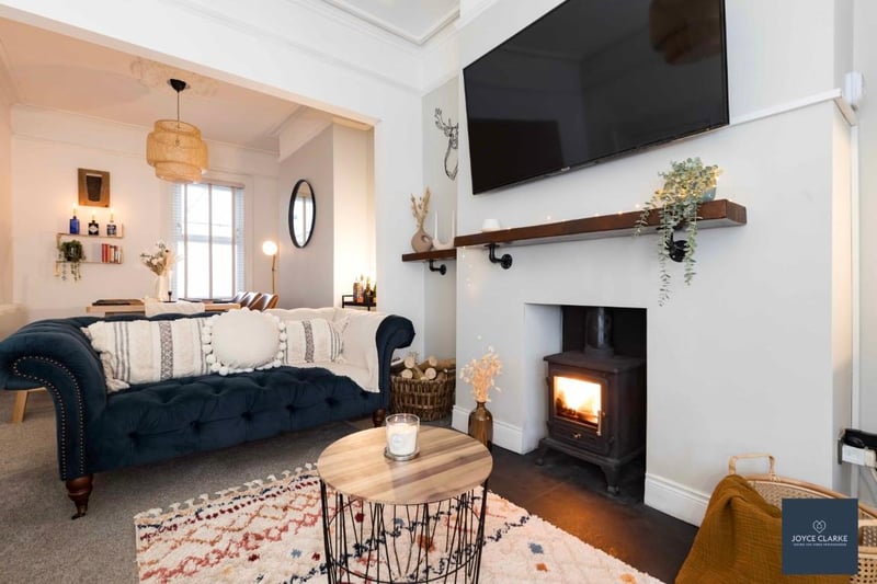 The dual aspect living / dining room has period style features with beautiful ceiling cornicing and centre rose and a multi fuel stove with reclaimed floating beam mantle.