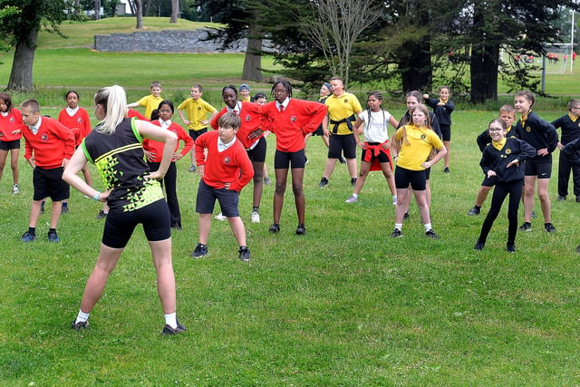 Pupils from Presentation Primary School  and Hart Memorial Primary School are put through their paces by a coach from Healthy Kidz at the Shared Education Fun Day in Portadown People's Park on Wednesday. PT24-200.
