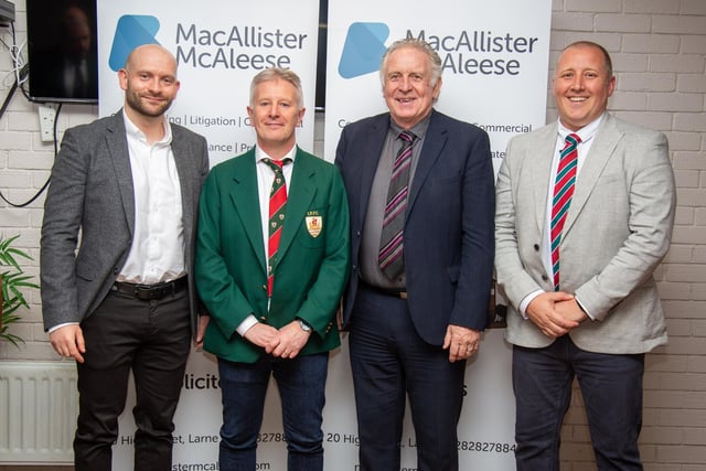 Former Northern Ireland international footballer Gerry Armstrong with club members at Larne RFC's annual dinner.