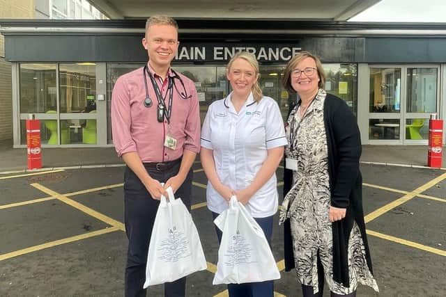Andrew and Gemma receiving their SAS NI goody bags from SAS Lead, Dr Joanne Younge.