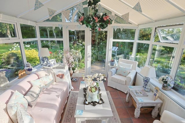 The conservatory (11'11“ x 10'9") has double doors leading to the lovely garden.