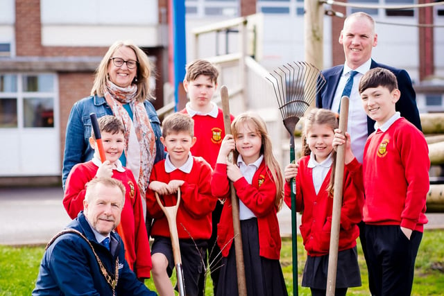 The Mayor of Antrim and Newtownabbey, Alderman Stephen Ross, helps pupils and staff at Carnmoney Primary School to plant their tree