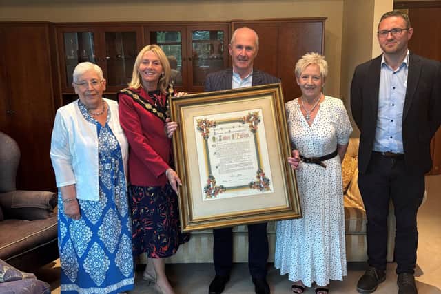 Mayor of Lisburn & Castlereagh City Council, Ald Amanda Grehan with Charlie Stewart and members of his Family - who donated a framed Illuminated Address from Lisburn Silver Band to Dr Ciaran Toal of the Irish Linen Centre and Lisburn Museum.