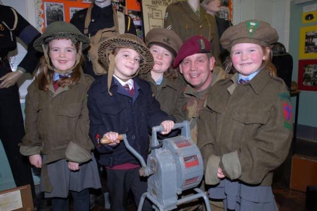 David McCallion brought his War Years Remembered exhibition to Upper Ballyboley Primary School in 2007. He is pictured with Erin Spence, Sophie McGookin, Rhonda Currie and Rachel Stewart as they work an air raid siren.