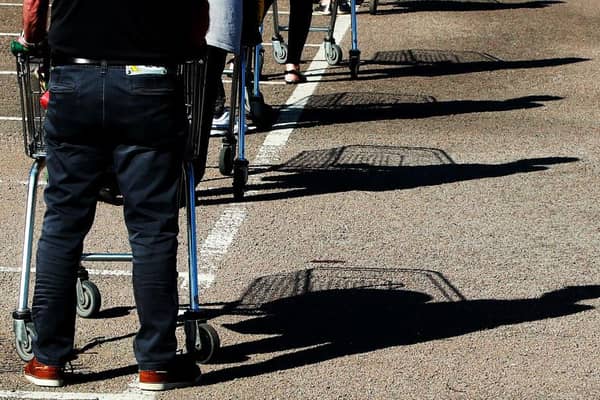 Shoppers queue using safe distance measures at Waitrose supermarket in Rushden, England (Photo: David Rogers/Getty Images)