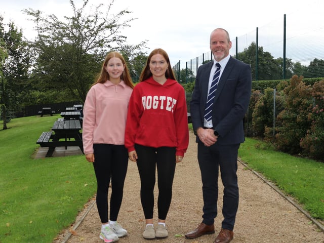 St Mary's Grammar School Principal Mr Paul McClean pictured with two of the successful GCSE students.