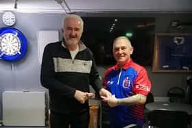 Chairman of Lisnagarvey Darts League Alan Carlisle presents the sponsorship cheque to Raymond Williamson