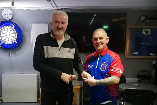 Chairman of Lisnagarvey Darts League Alan Carlisle presents the sponsorship cheque to Raymond Williamson