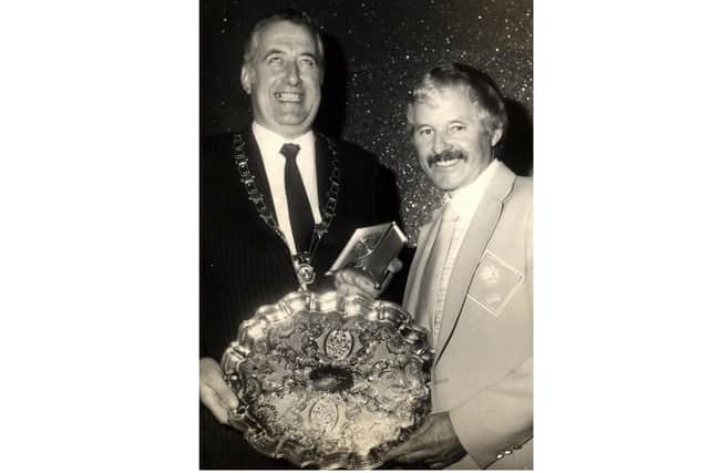Newry and Mourne chairperson John McEvoy presents Jackie Poucher with the 1984 Newry and Mourne Services to Sport award.