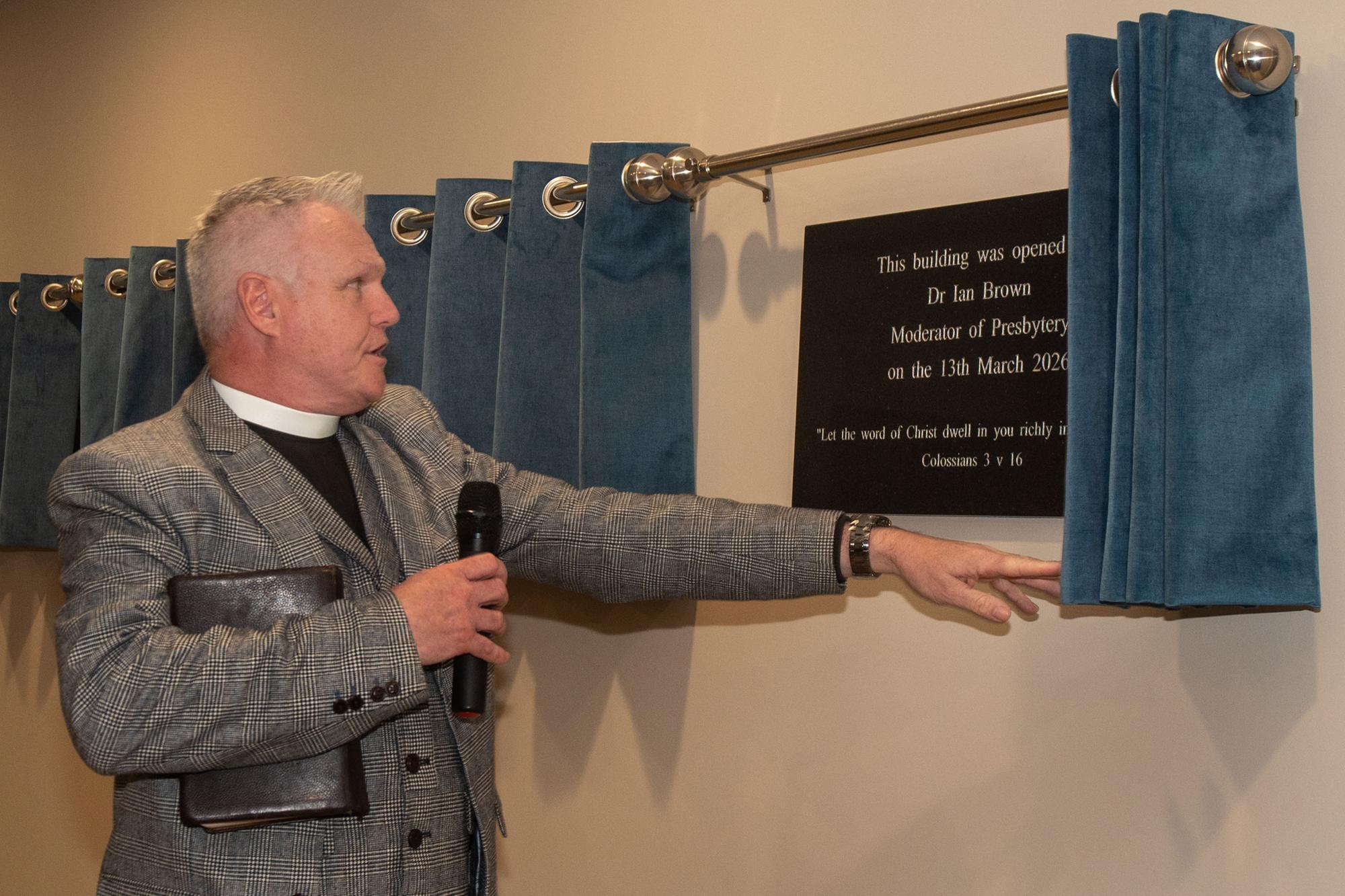 Free Presbyterian Church moderator Dr Ian Brown unbeils one of the plaques at the opening of the new Whitefield College of the Bible.