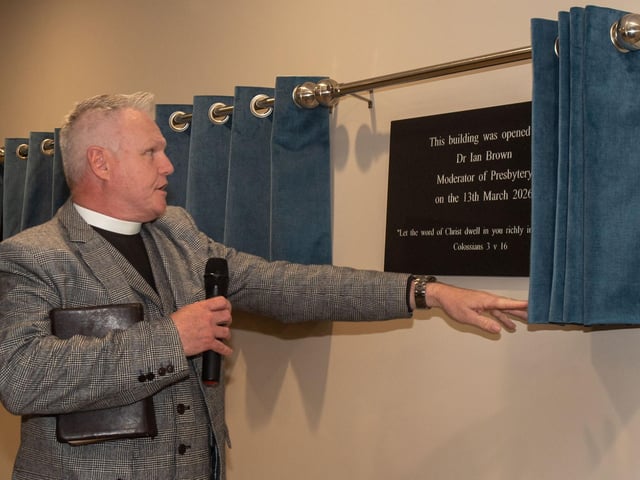 Free Presbyterian Church moderator Dr Ian Brown unbeils one of the plaques at the opening of the new Whitefield College of the Bible.