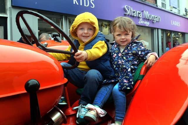 Sitting pretty on a vintage tractor at Country Comes To Town on Saturday are Ronnie and Rosie McCann. PT38-219.