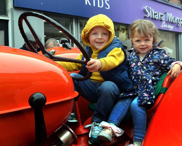 Sitting pretty on a vintage tractor at Country Comes To Town on Saturday are Ronnie and Rosie McCann. PT38-219.