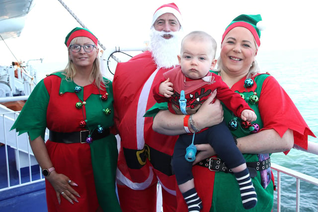 Pictured (l-r) Nicky Newman from Coleraine, Santa aka Neil Dickey from Coleraine, Wendy Wright from Ballymoney with Jacob Black from Bangor.