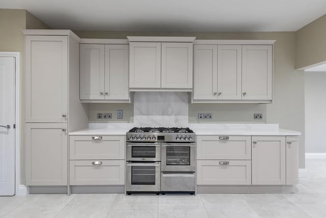 The well-designed kitchen area has an excellent range of eye and low level units with quartz worktop.