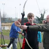 Minister Lyons tries his hand at archery at the Celebration of Sport event in Carrickfergus. Photo:submitted
