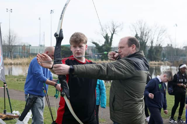 Minister Lyons tries his hand at archery at the Celebration of Sport event in Carrickfergus. Photo:submitted