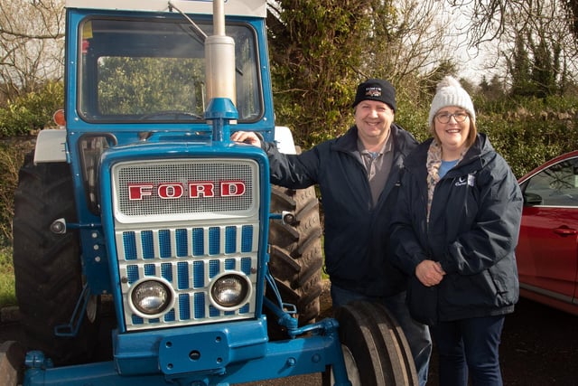 Ronald and Allison Johnston pictured with their son Robert's newly restored 1974 Ford tractor at the charity tractor run. PT12-282.