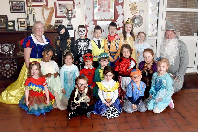 Key Stage One pupils of St John The Baptist Primary School and Bunscoil posing as their favourite book characters with principal, Mr John McComb and classroom assistant, Mrs Caroline Burns. PT10-221.