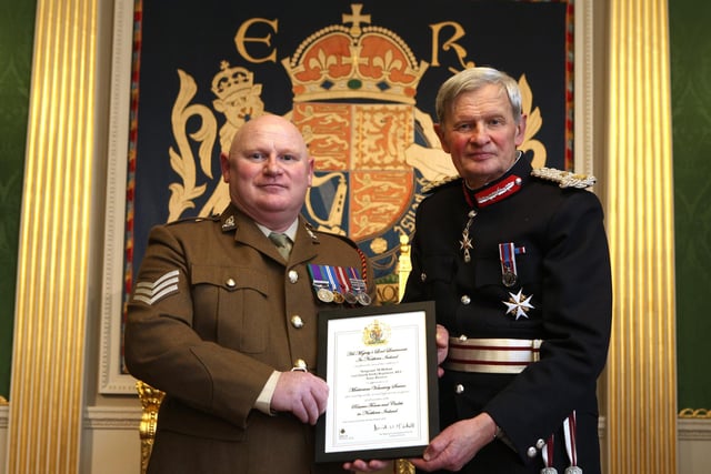 Sergeant Mark Hoban was recognised for ‘his contribution to both the Army Reserves and wider society through significant charitable work.’  That charitable work includes generating significant support over the years for The Alzheimer’s Society and the Friends of Carrick Manor Nursing Home.
Sergeant Hoban’s primary focus within the Reserve Forces lies in managing the complex issues of pay and administration which support his colleagues in 152 Royal Logistics Corps.  This he does to the highest standards and he has played a critical role in preparing for recent deployments.
In recent years he has also deployed twice to the USA to take part in inter-operability exercises with the US Army, becoming, according to the Citation, ‘a revered member of his Regiment, always seeking out opportunities to provide a first class service’.
Sergeant Mark Hoban is pictured receiving certificate and congratulations from Mr David McCorkell,