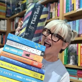 Lesley Price, from Bridge Books, Dromore, proudly displaying her Ulster Tatler 'Businesswoman of the Year' award on top of a pile of books she has recently read and loves. Photo: Lesley Price