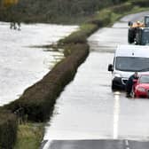 A motorist gets stuck in flooding on the main Portadown-Loughgall Road on Tuesday. PT44-247.