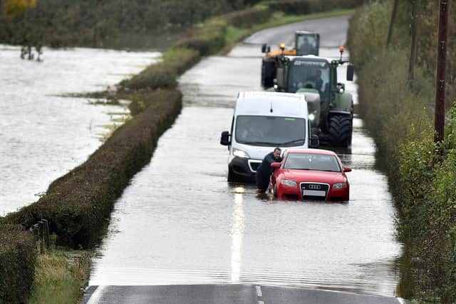 A motorist gets stuck in flooding on the main Portadown-Loughgall Road on Tuesday. PT44-247.