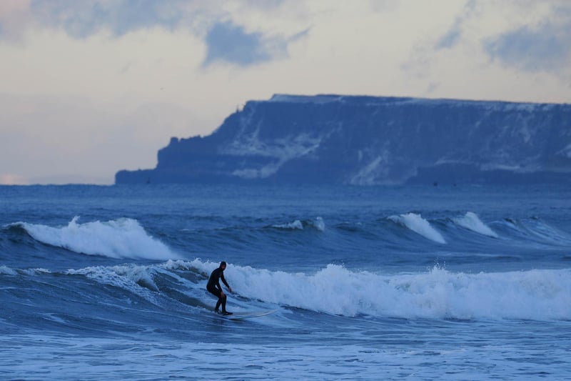 Cameron Leighton enjoys the surf on White Rocks beach after hitting the slopes