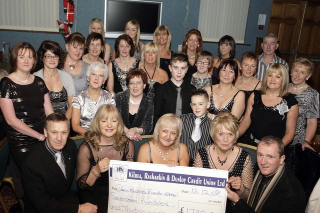 Pictured (seated centre) is Vera McGerr from Tonky Tonk Line-dancers, who presented Edwina Chambers (right) and Breige McAuley with a cheque for the magnificent sum of £1,730.00 in 2008 at McLaughlin's Corner. The money will go towards the Drop In Rwanda Appeal and included are line-dancers who raised the amount