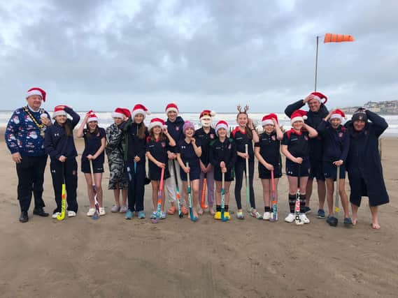 Pictured holding onto their Santa hats during their sea dip debut on Portstewart Strand are the brave Year 8 pupils from Coleraine Grammar School; Amber Miller, Anna McGreevy, Elise Archibald, Erin Semple, Eva Grace Patterson, Isabella McCarron, Jasmine Moore, Jessica Cartmill, Josie Dixon, Lucy Blackstock, Poppy Ewing, Sarah McCaughey and Tilly Lyttle. Also included are Mr Semple, Mr Cartmill and mayor of Causeway Coast and Glens, councillor Steven Callaghan