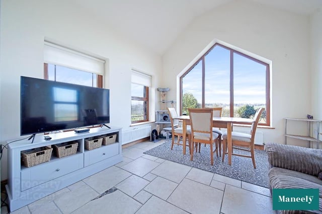 Sun room with vaulted ceiling and church-style feature window with panoramic views.