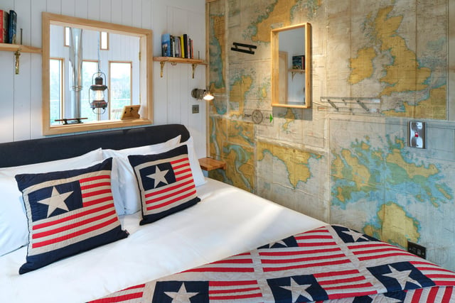 The king sized bedroom comes complete with quirky nautical wallpaper.