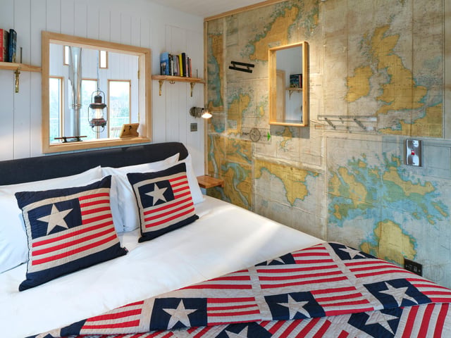 The king sized bedroom comes complete with quirky nautical wallpaper.