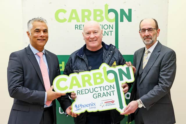 Kailash Chada (Chief Executive Officer at Phoenix Energy), Newtownabbey-based installer Stephen Meneely and Terry Waugh (Chief Executive Officer at Action Renewables). (Pic: Justin Kernoghan).