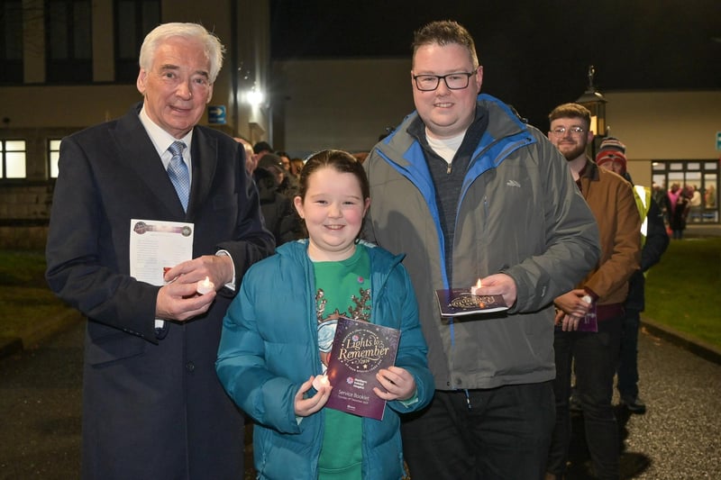 Christopher Smith and his eight-year-old daughter Meabh with Paul Clark MBE, president of NI Hospice.