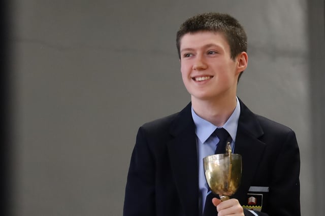 One of the pupils pictured receiving his prize.