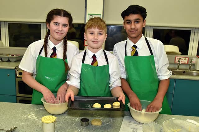 Lurgan Junior High School pupils Faith Currie, Harry Mackle and Sulaiman Arfan prepare some tasty food in the Home Economics department during the Lurgan Junior High School open night. LM02-203.