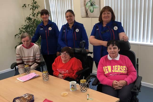Pictured, from left, are checkout operators Andrea da Silva Pais and Michelle Taggart and Community Champion and Customer Service Desk Assistant Sharon Allen during visit to Willowbank Community Resource Centre users. Credit: Submitted