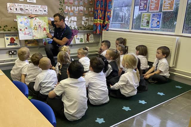 Cool FM's Paulo Ross reads a story to some of the young pupils at Victoria Primary School in Carrickfergus.  Photo: Victoria PS