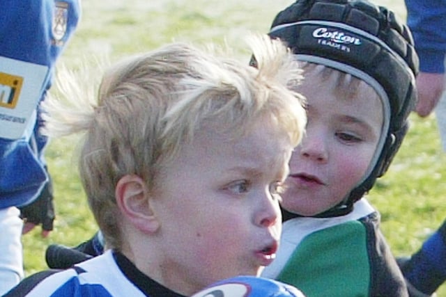 A young player keeps possession in confident style at the Mini Rugby Blitz at Coleraine Rugby Club in 2011.