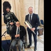 D-Day veteran and Carrickfergus man George Horner pictured with piper, Grahame Harris and East Antrim MLA John Stewart at Parliament Buildings for the 'Lighting their Legacies' event, part of the 80th Anniversary of D-Day commemorations.  Photo: John Stewart MLA